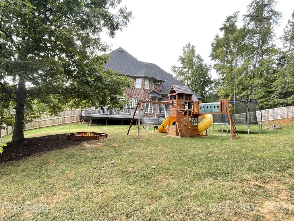 4004 Lamington Road Matthews, NC 28105 - Photo 27 of 31 a backyard of a house with barbeque oven table and chairs
