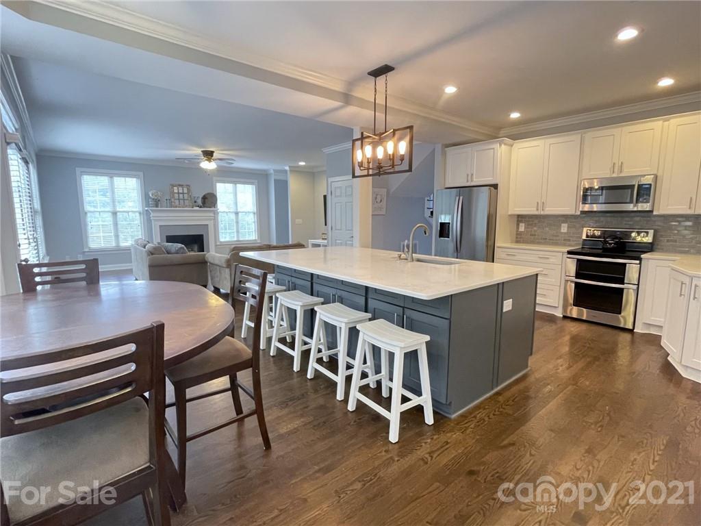4004 Lamington Road Matthews, NC 28105 - Photo 4 of 31 a large kitchen with a table and chairs