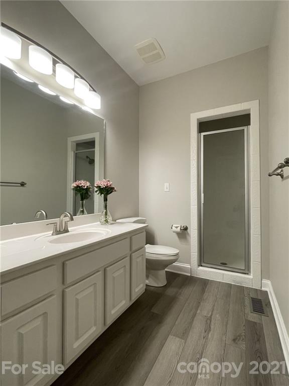 4004 Lamington Road Matthews, NC 28105 - Photo 8 of 31 a bathroom with a toilet sink and mirror