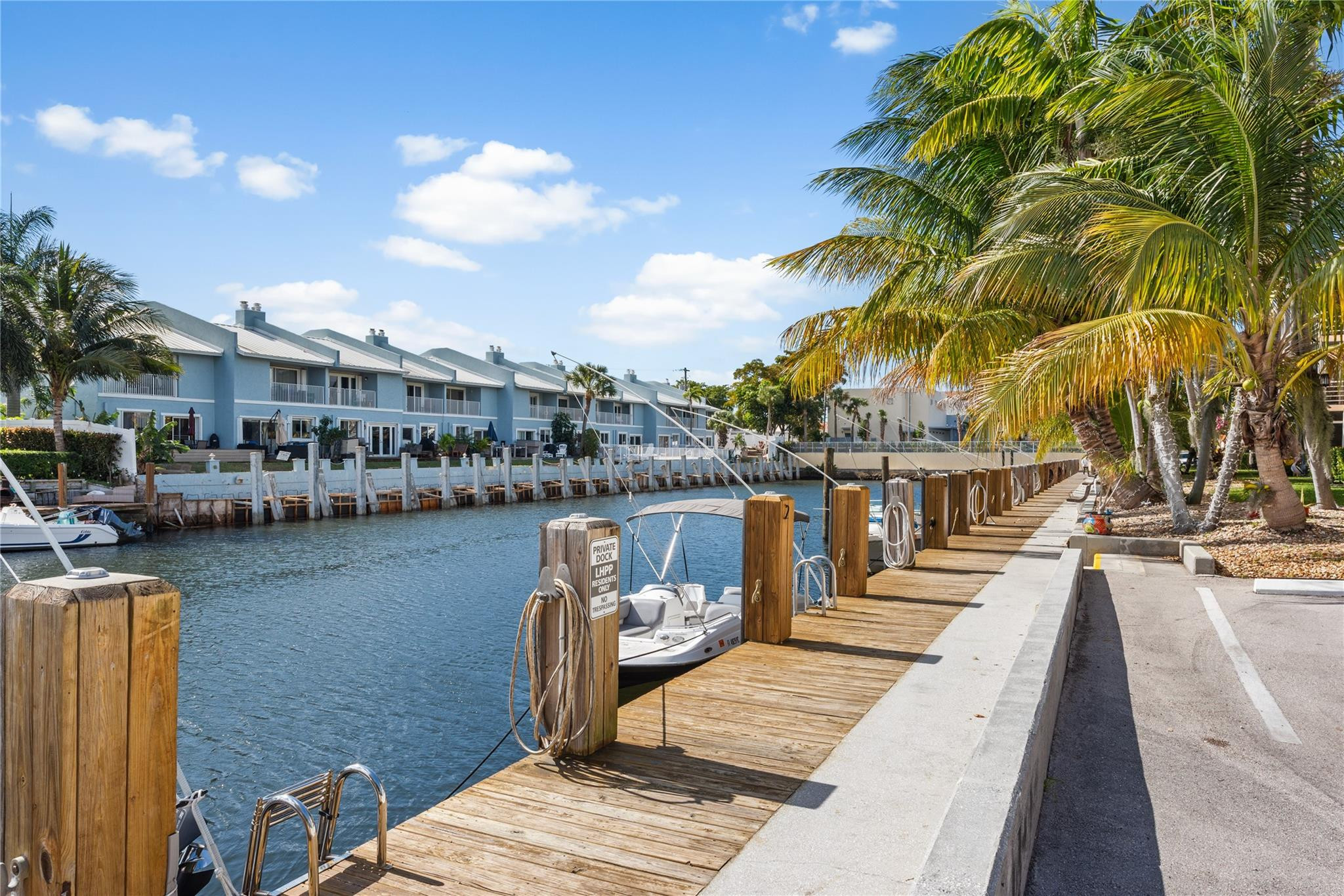4500 North Federal Highway, Unit 156 Lighthouse Point, FL 33064 - Photo 19 of 23 a view of a lake with boats and palm trees