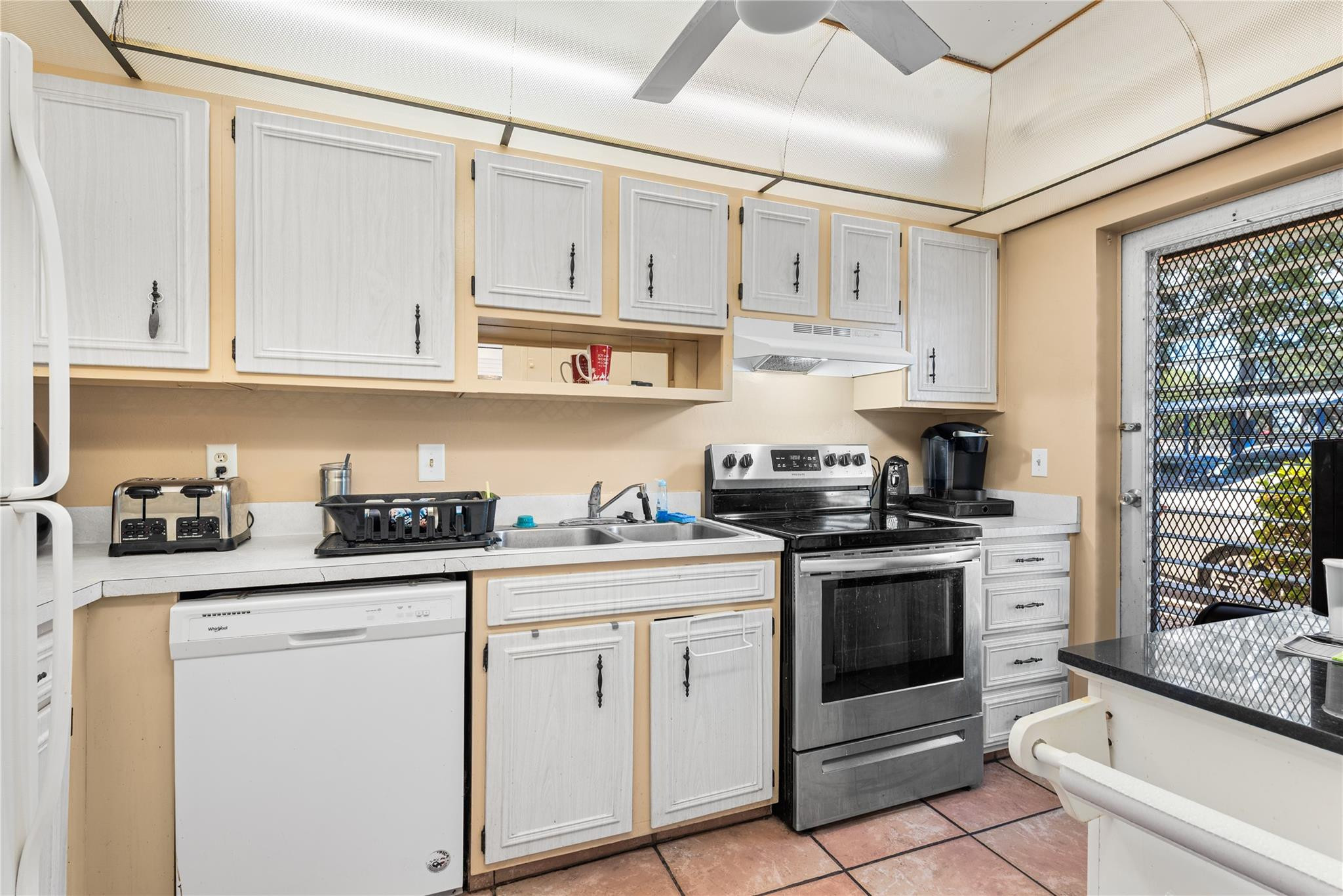 4500 North Federal Highway, Unit 156 Lighthouse Point, FL 33064 - Photo 5 of 23 a kitchen with granite countertop white cabinets and white appliances
