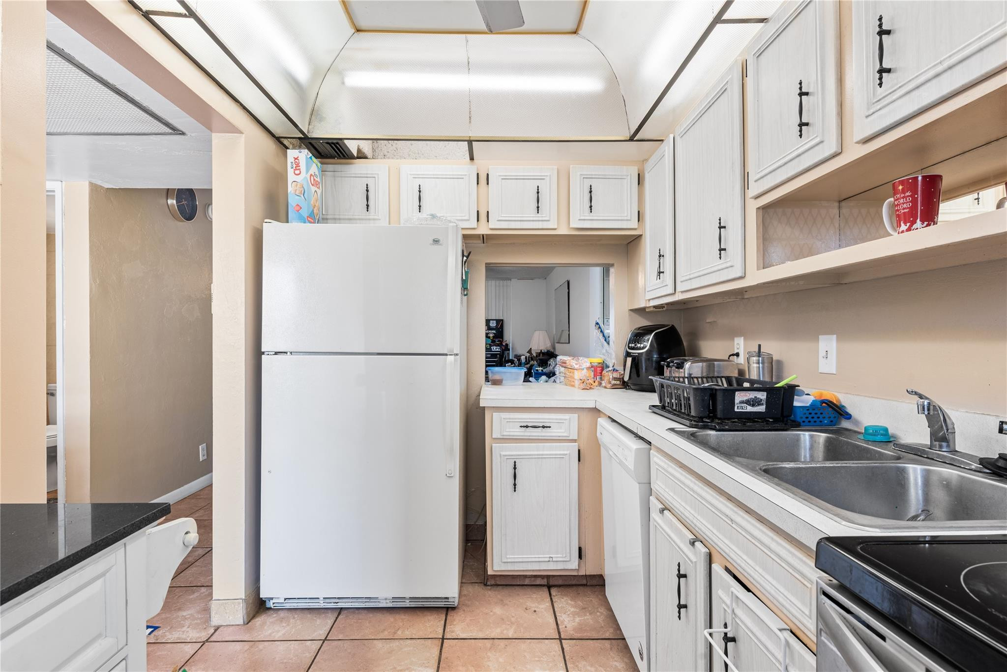 4500 North Federal Highway, Unit 156 Lighthouse Point, FL 33064 - Photo 6 of 23 a kitchen with stainless steel appliances a refrigerator sink and cabinets