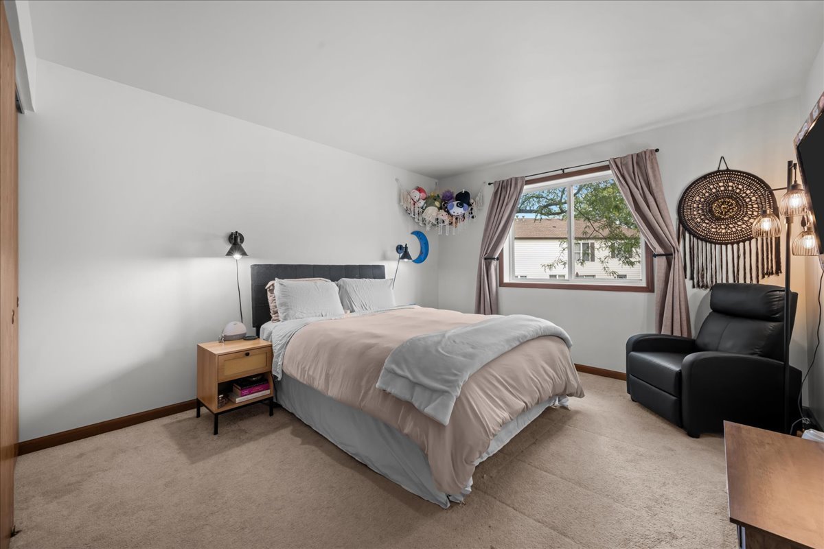 2691 Stanton Court Aurora, IL 60502 - Photo 13 of 17 a bed room with a bed and a chair