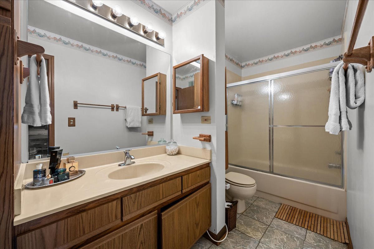 2691 Stanton Court Aurora, IL 60502 - Photo 15 of 17 a bathroom with a sink a toilet and shower