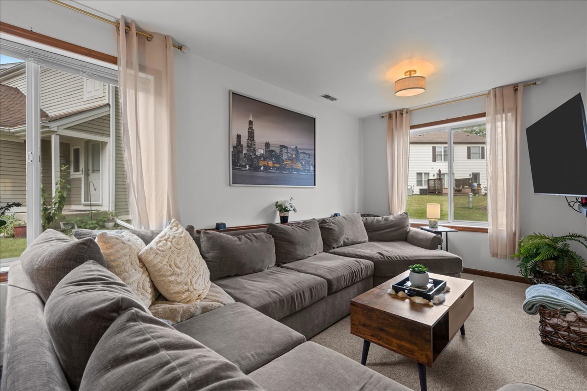 2691 Stanton Court Aurora, IL 60502 - Photo 5 of 17 a living room with furniture a flat screen tv and a window