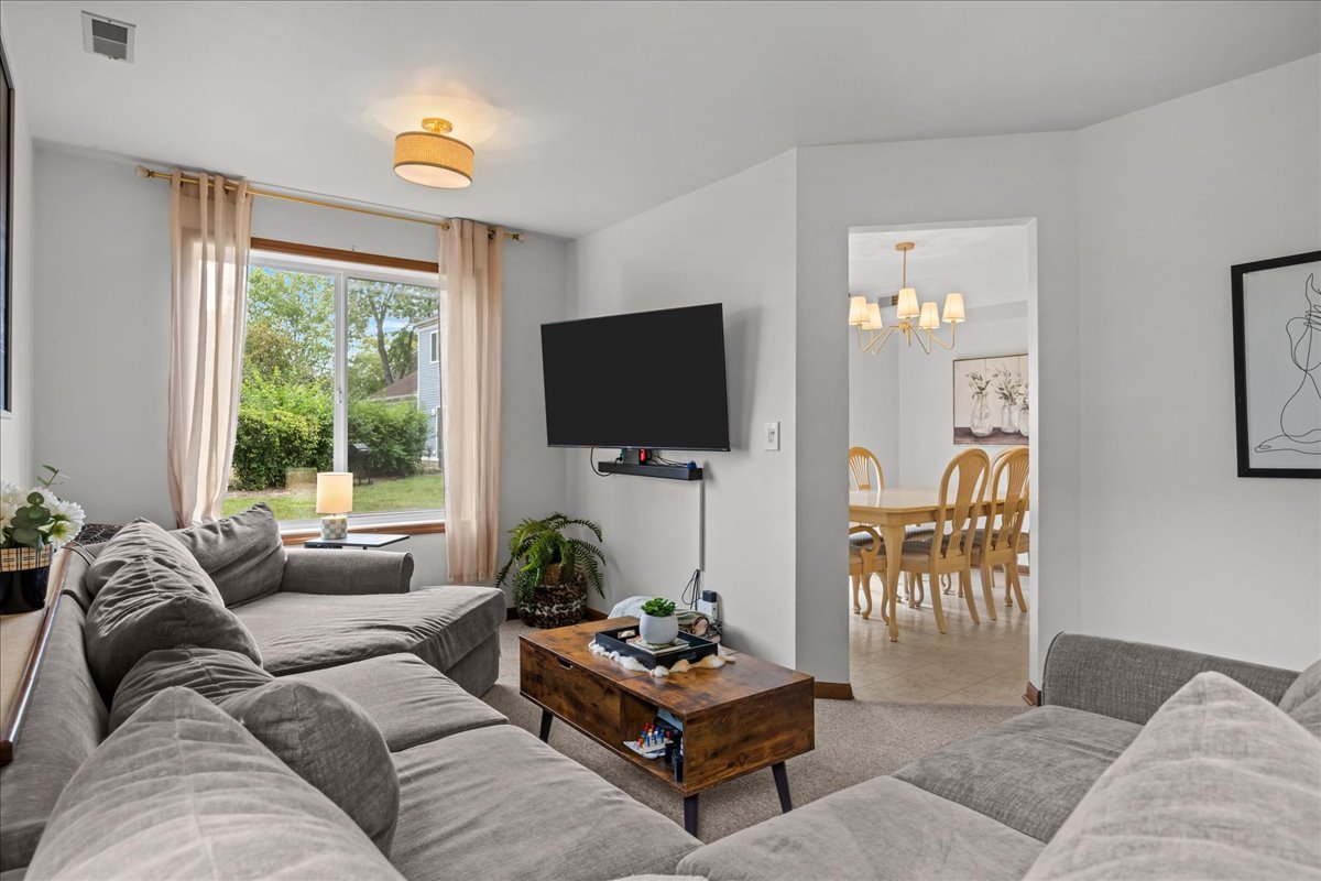 2691 Stanton Court Aurora, IL 60502 - Photo 6 of 17 a living room with furniture and a flat screen tv