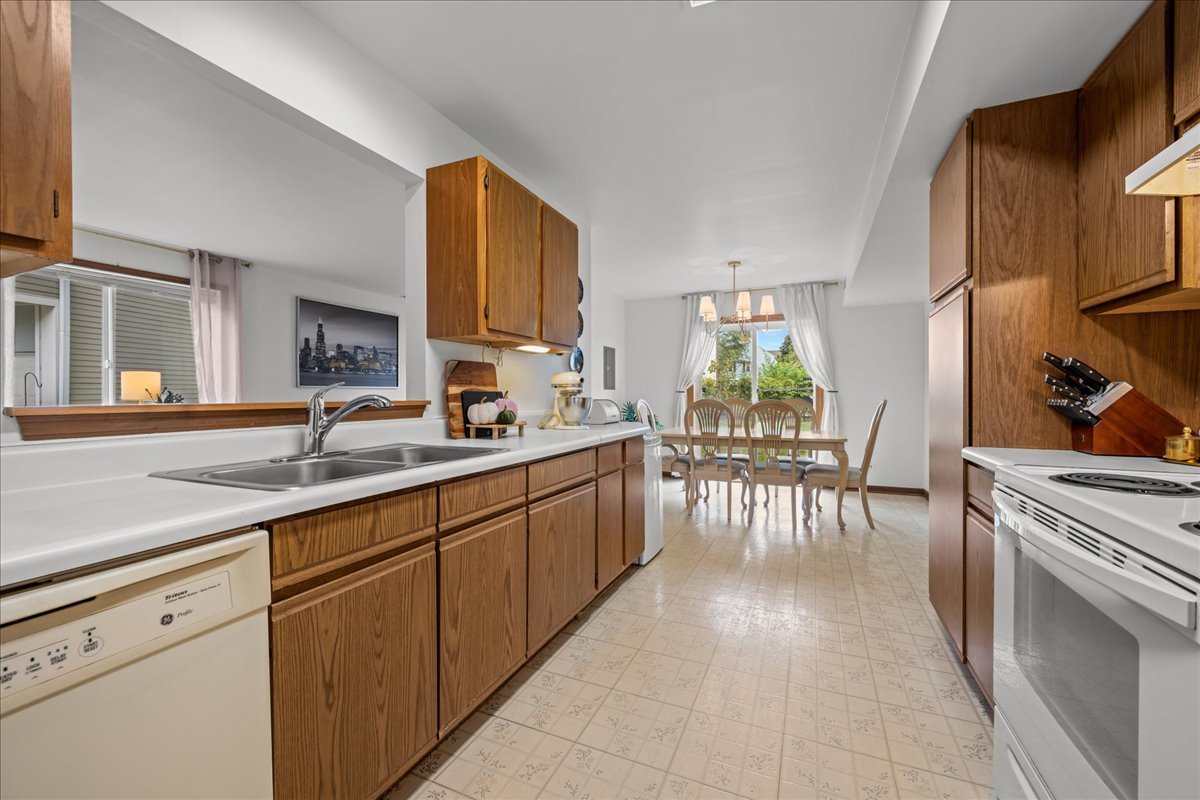 2691 Stanton Court Aurora, IL 60502 - Photo 10 of 17 a kitchen with stainless steel appliances granite countertop sink window and cabinets