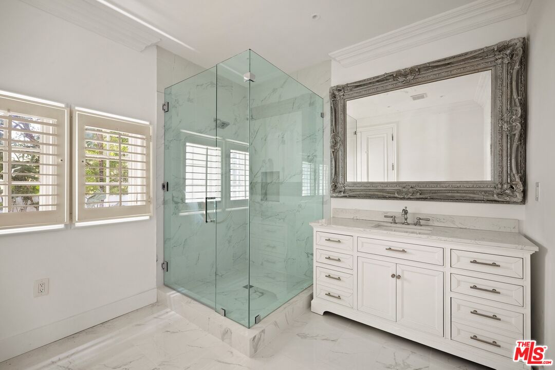 9609 Oak Pass Road Beverly Hills, CA 90210 - Photo 12 of 16 a bathroom with a granite countertop sink mirror and
