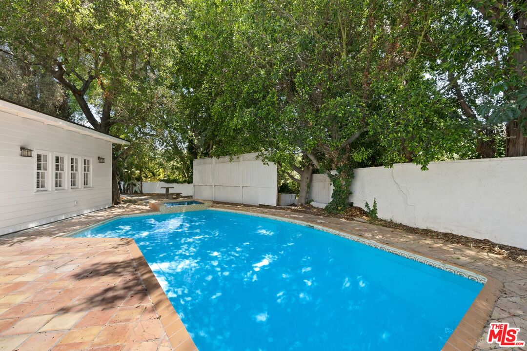 9609 Oak Pass Road Beverly Hills, CA 90210 - Photo 2 of 16 a backyard of a house with table and chairs