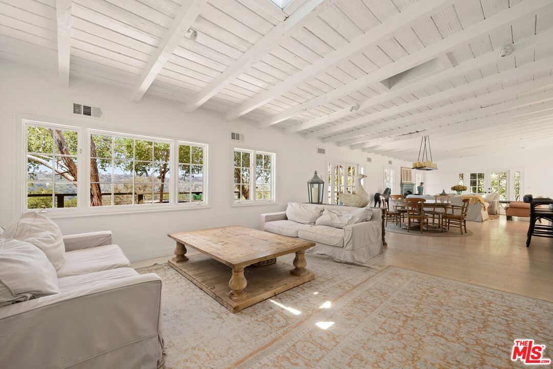 9609 Oak Pass Road Beverly Hills, CA 90210 - Photo 4 of 16 a living room with furniture and a large window
