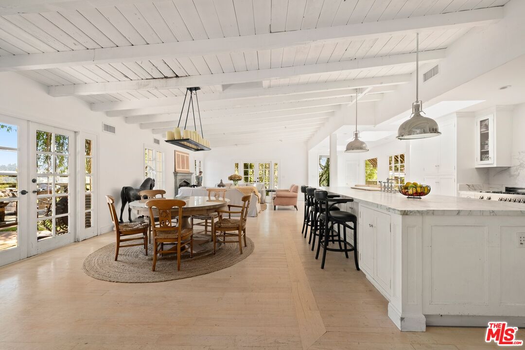 9609 Oak Pass Road Beverly Hills, CA 90210 - Photo 5 of 16 a view of a dining room and livingroom with furniture wooden floor a chandelier
