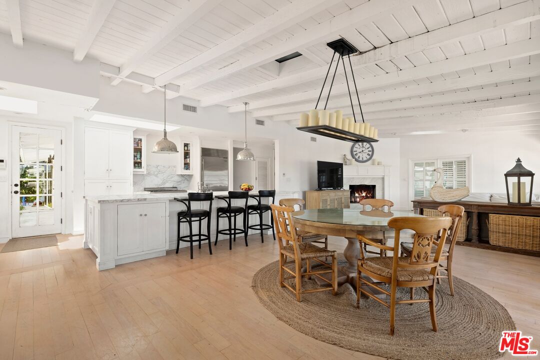 9609 Oak Pass Road Beverly Hills, CA 90210 - Photo 6 of 16 a view of a dining room with furniture window and wooden floor