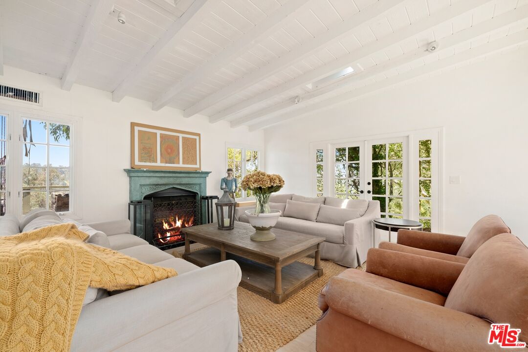 9609 Oak Pass Road Beverly Hills, CA 90210 - Photo 7 of 16 a living room with furniture and a fireplace
