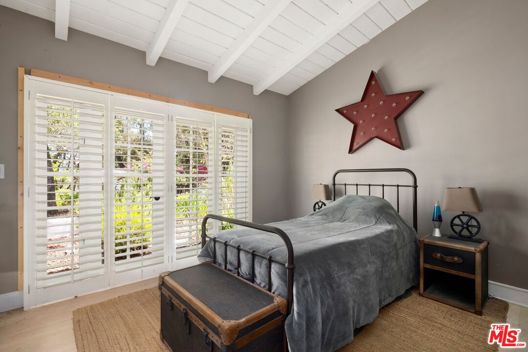 9609 Oak Pass Road Beverly Hills, CA 90210 - Photo 10 of 16 a bedroom with a bed and wooden floor