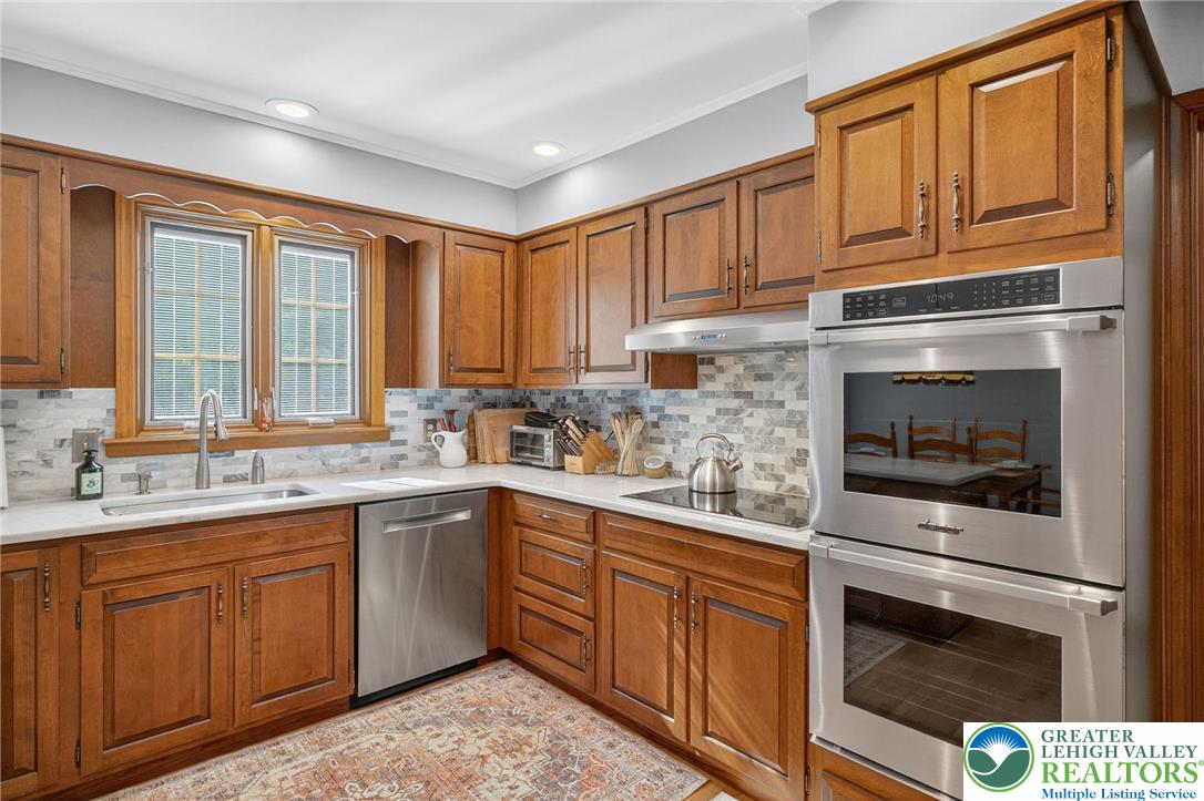 1830 Sherwood Road Allentown, PA 18103 - Photo 12 of 68 a kitchen with stainless steel appliances granite countertop a stove microwave and cabinets