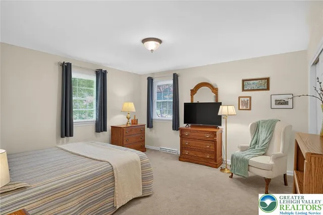 a living room with furniture and a book shelf