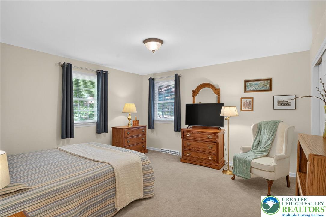 1830 Sherwood Road Allentown, PA 18103 - Photo 32 of 68 a bedroom with a bed and dresser with mirror