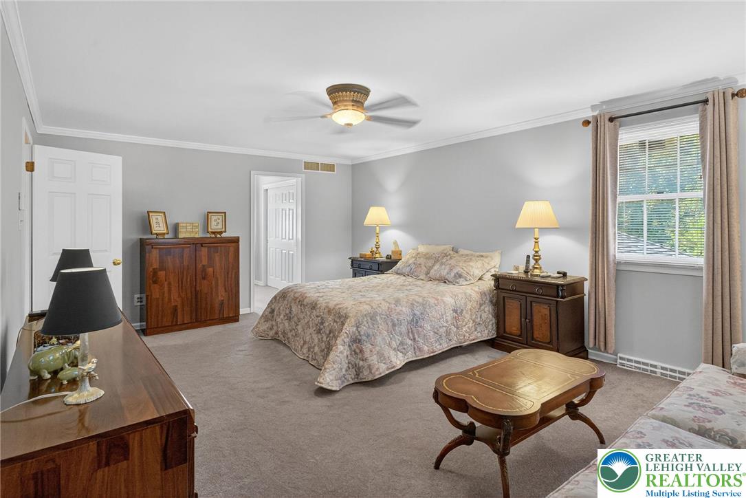 1830 Sherwood Road Allentown, PA 18103 - Photo 33 of 68 a bedroom with a bed and a chandelier