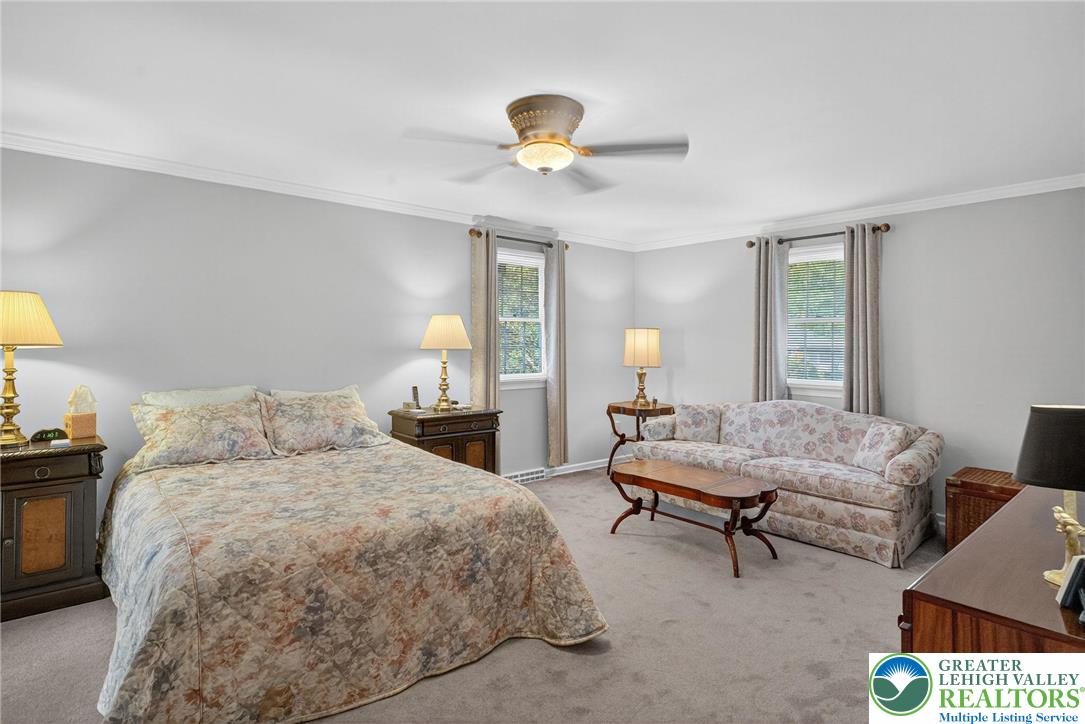 1830 Sherwood Road Allentown, PA 18103 - Photo 34 of 68 a bedroom with a bed and a chandelier