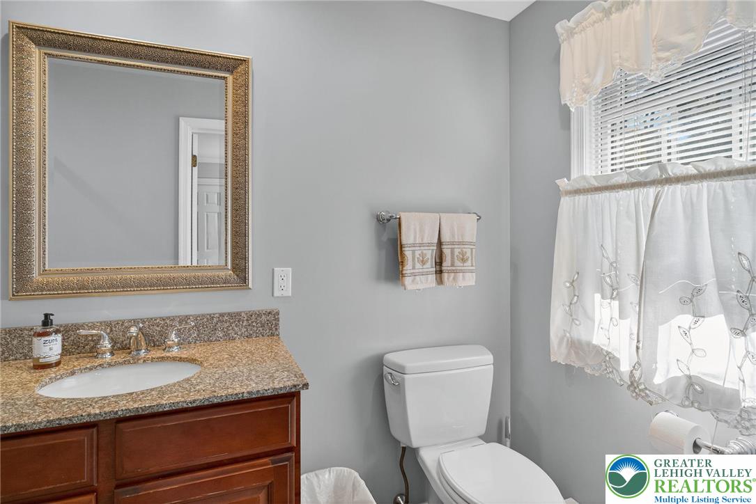 1830 Sherwood Road Allentown, PA 18103 - Photo 36 of 68 a bathroom with a granite countertop toilet sink and mirror