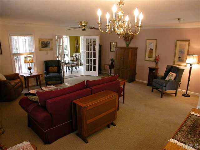 1515 Laureldale Drive Raleigh, NC 27609 - Photo 5 of 25 a living room with furniture and a chandelier