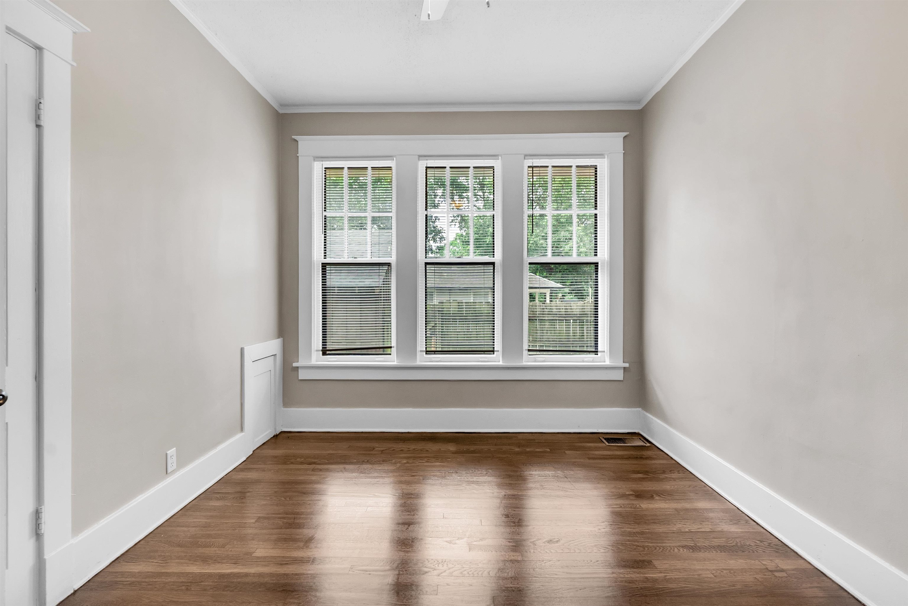 2579 Hale Avenue Memphis, TN 38112 - Photo 17 of 21 a view of an empty room with wooden floor and a window