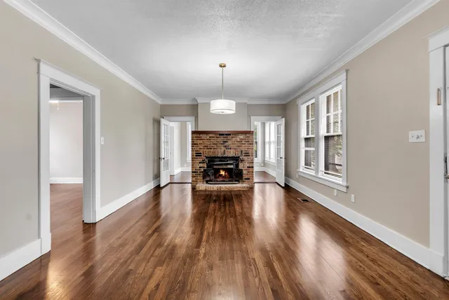 wooden floor fireplace and natural light in room