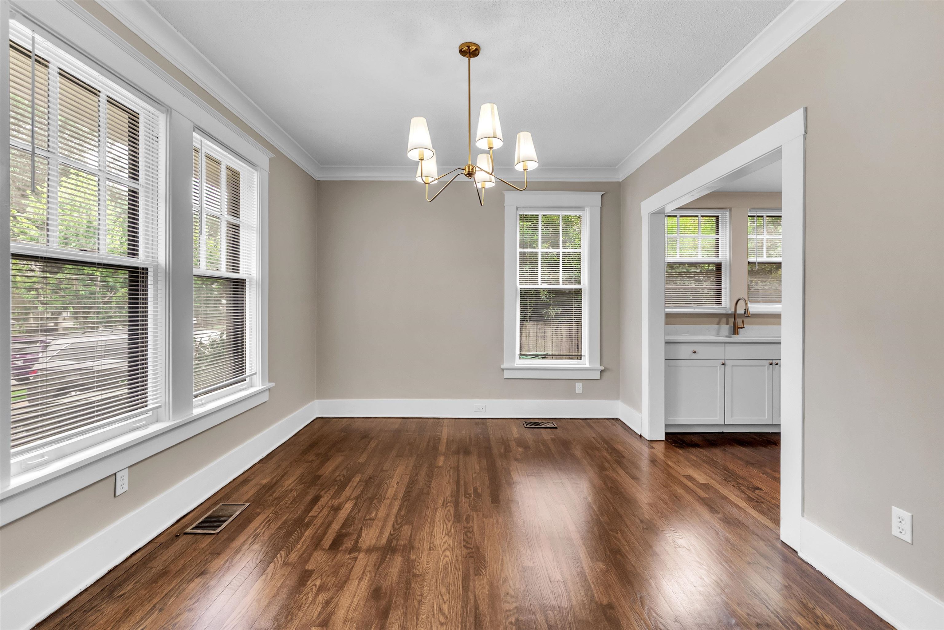 2579 Hale Avenue Memphis, TN 38112 - Photo 7 of 21 an empty room with wooden floor chandelier and windows