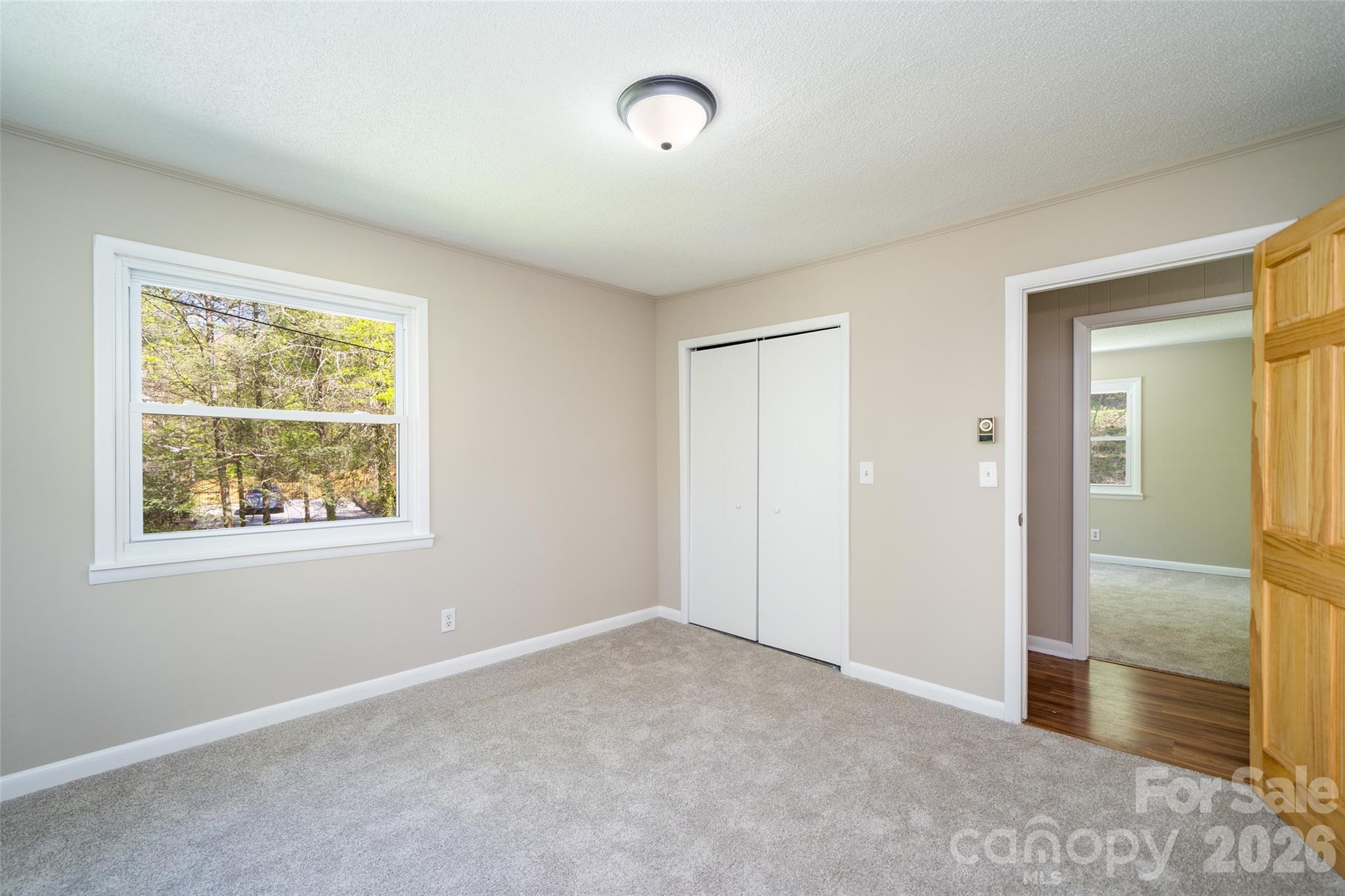 145 Jeter Mountain Road Hendersonville, NC 28739 - Photo 11 of 13 an empty room with windows