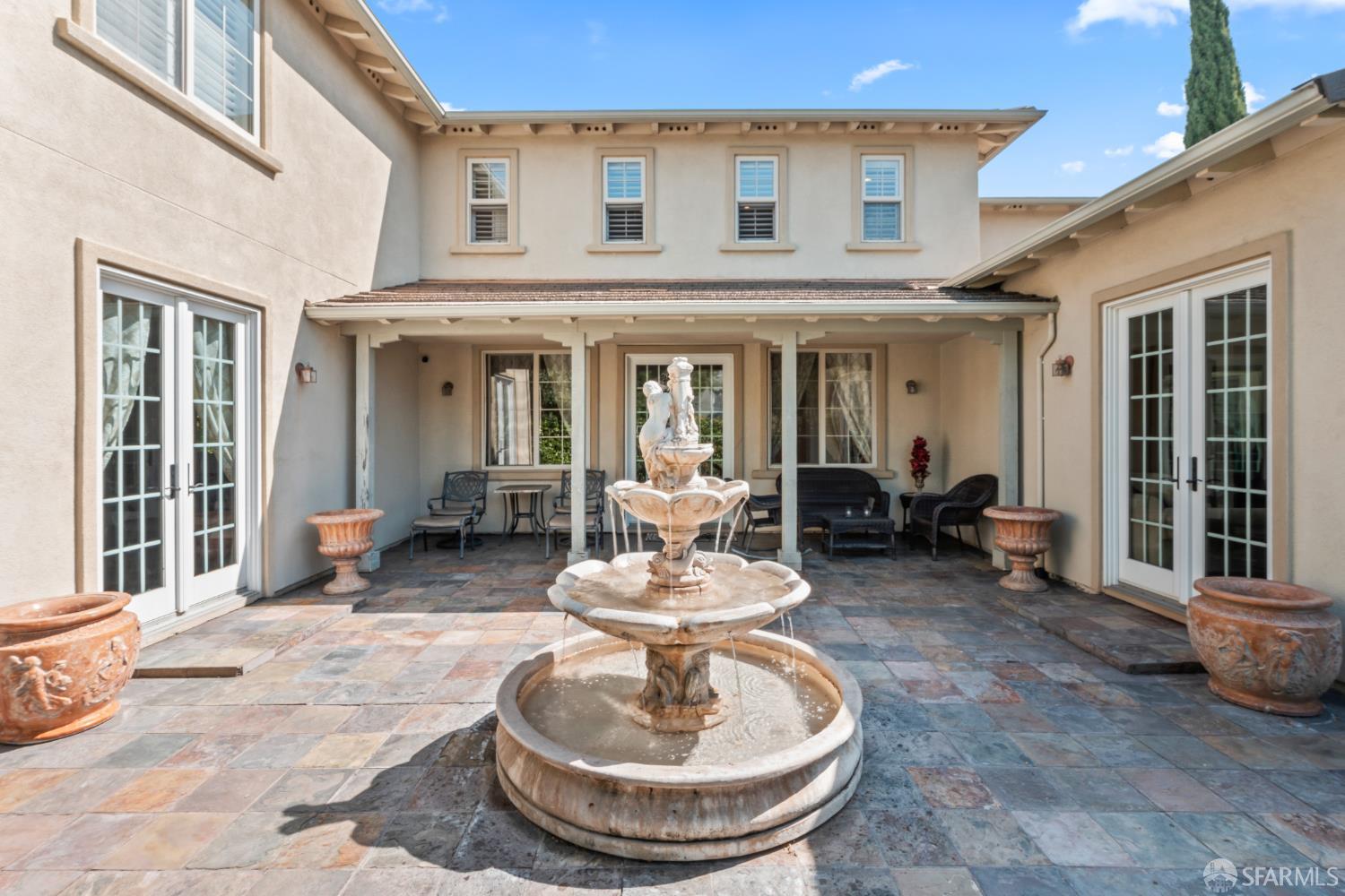 103 Abalone Cove Hercules, CA 94547 - Photo 66 of 84 a view of a patio with table and chairs potted plants and floor to ceiling window