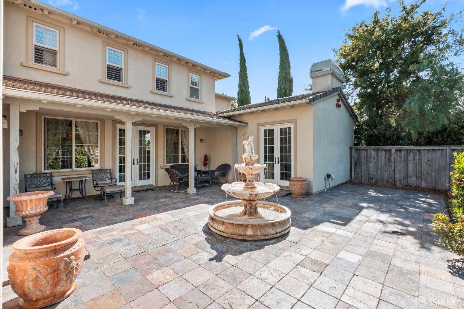 103 Abalone Cove Hercules, CA 94547 - Photo 67 of 84 a view of a patio with table and chairs potted plants and wooden fence