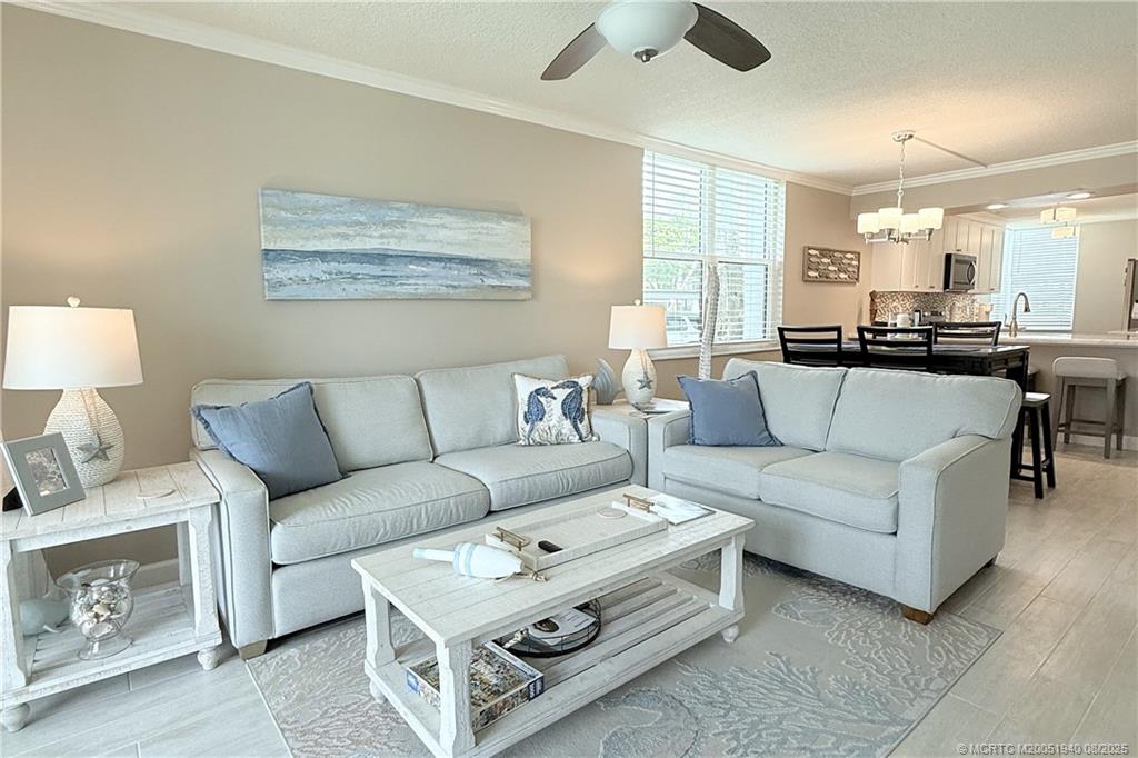 1950 Southwest Palm City Road, Unit 9108 Stuart, FL 34994 - Photo 12 of 37 a living room with furniture and a large window