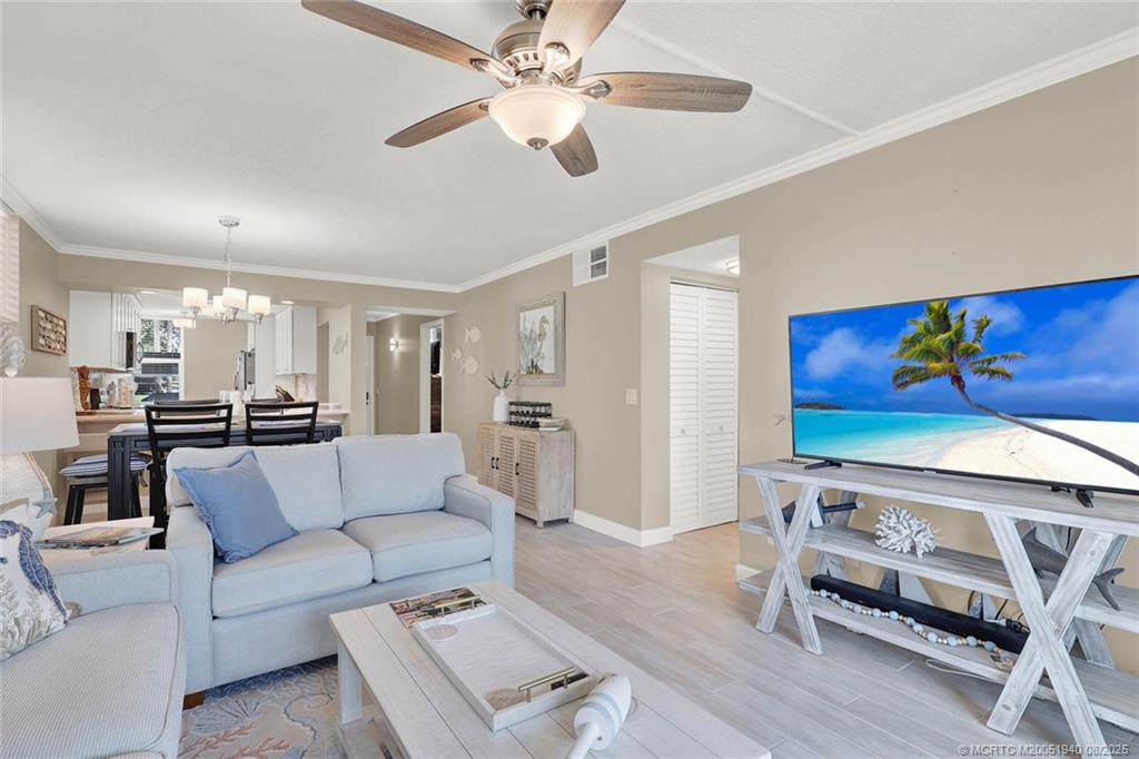 1950 Southwest Palm City Road, Unit 9108 Stuart, FL 34994 - Photo 14 of 37 a living room with furniture and wooden floor
