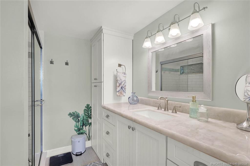 1950 Southwest Palm City Road, Unit 9108 Stuart, FL 34994 - Photo 24 of 37 a bathroom with a granite countertop sink and a mirror
