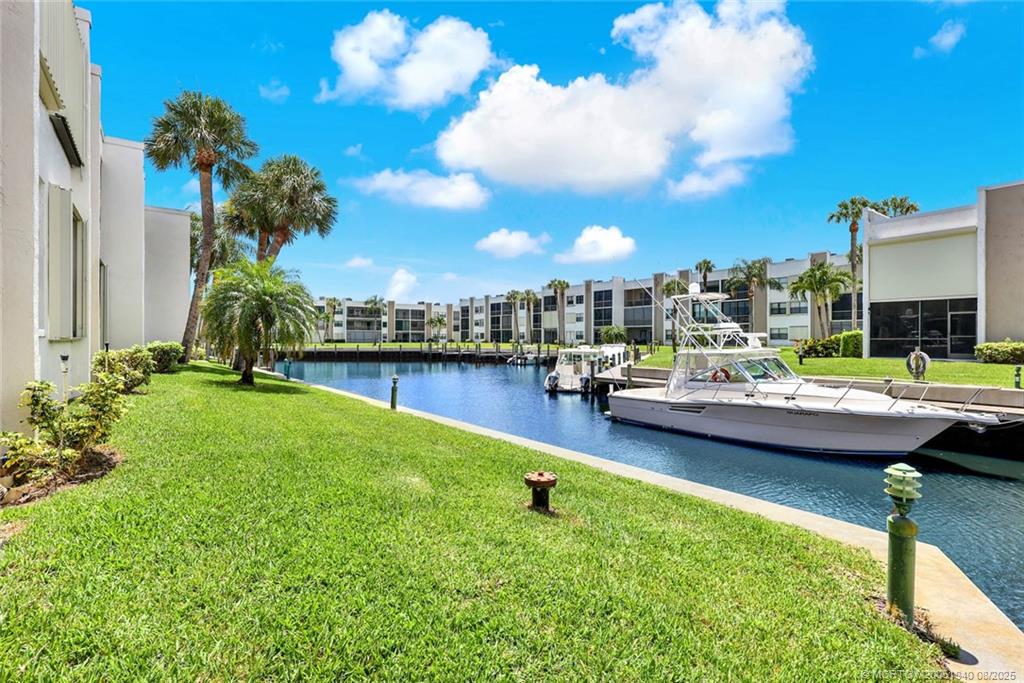 1950 Southwest Palm City Road, Unit 9108 Stuart, FL 34994 - Photo 31 of 37 a swimming pool with outdoor seating and yard