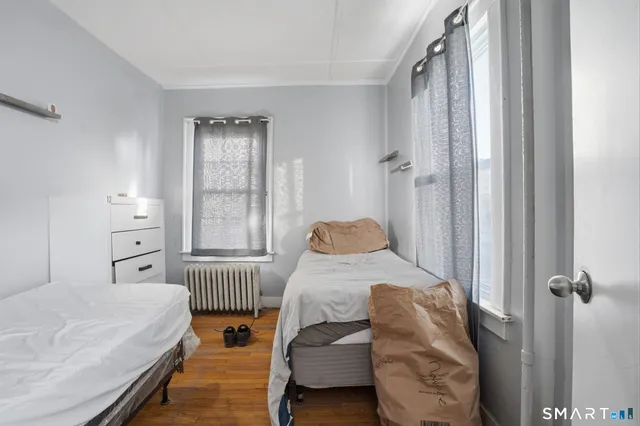 a bedroom with two beds and a window