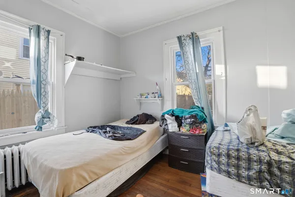 a bedroom with a bed and ceiling fan