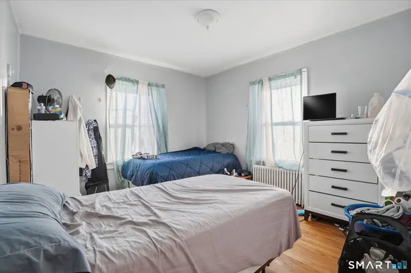 a bedroom with a bed and a television