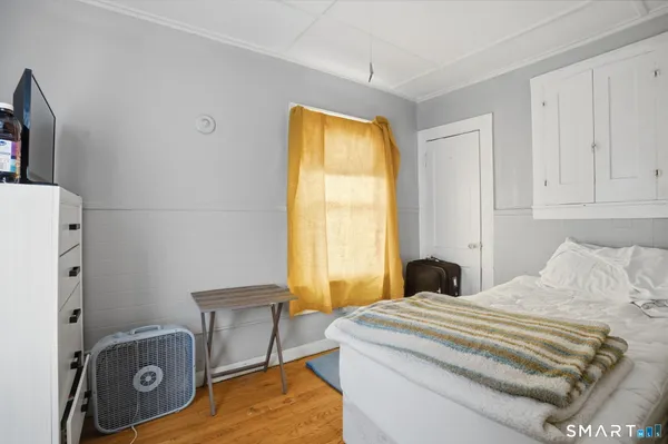 a bedroom with a bed and a window