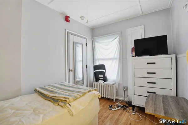 a bedroom with a bed and a flat screen tv