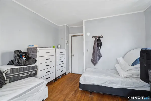 a bedroom with a bed and a dresser