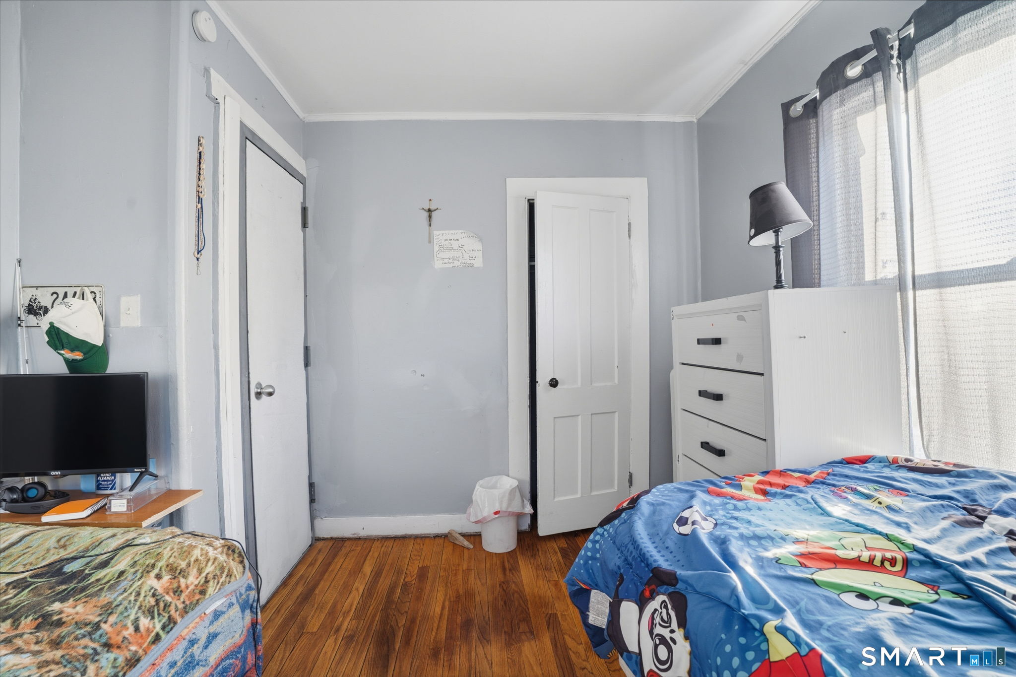 49 Birch Street Manchester, CT 06040 - Photo 25 of 30 a bedroom with a bed and a flat tv screen on dresser