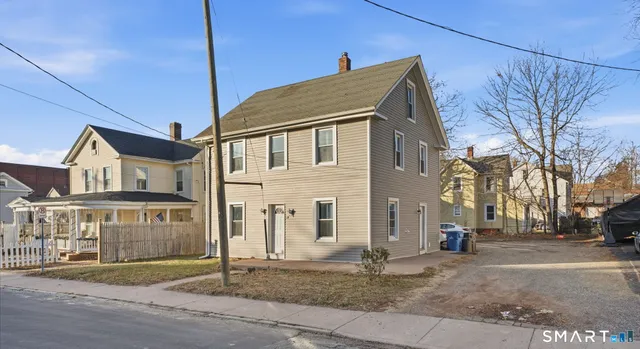 a view of a big house with a street