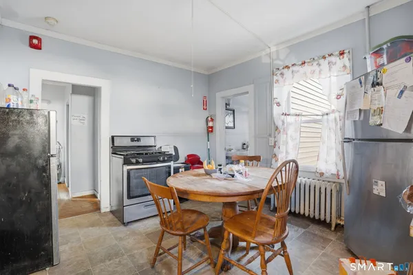 a dining room with furniture and window