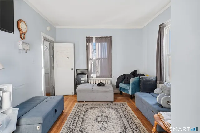 a bedroom with furniture and wooden floor