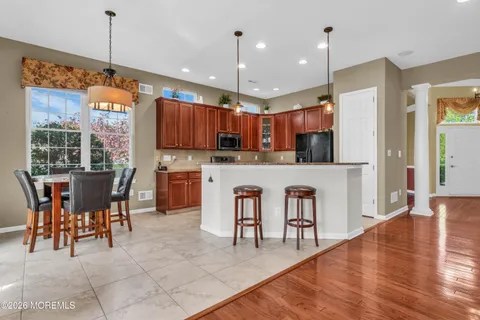 a kitchen with kitchen island granite countertop a sink and a stove