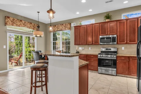a view of a dining room with furniture wooden floor and chandelier