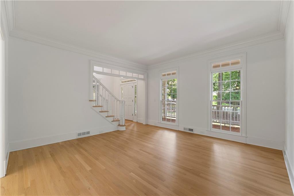 8965 Laurel Way Alpharetta, GA 30022 - Photo 20 of 79 a view of an empty room with wooden floor and a window