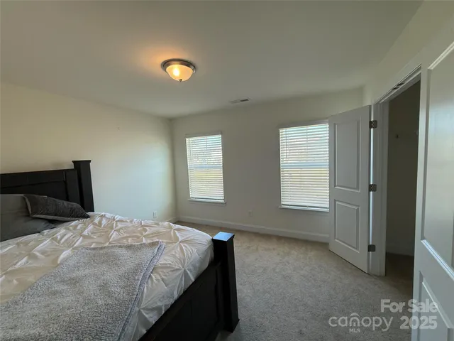 a spacious bathroom with a double vanity sink a mirror and shower