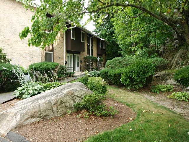 47 Rock Spring Road, Unit 23 Stamford, CT 06906 - Photo 1 of 1 a front view of a house with a yard